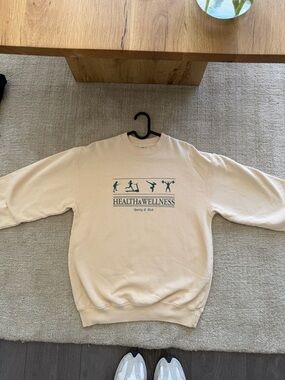 Sporty & Rich Cream Crewneck with Green Health & Wellness Graphic